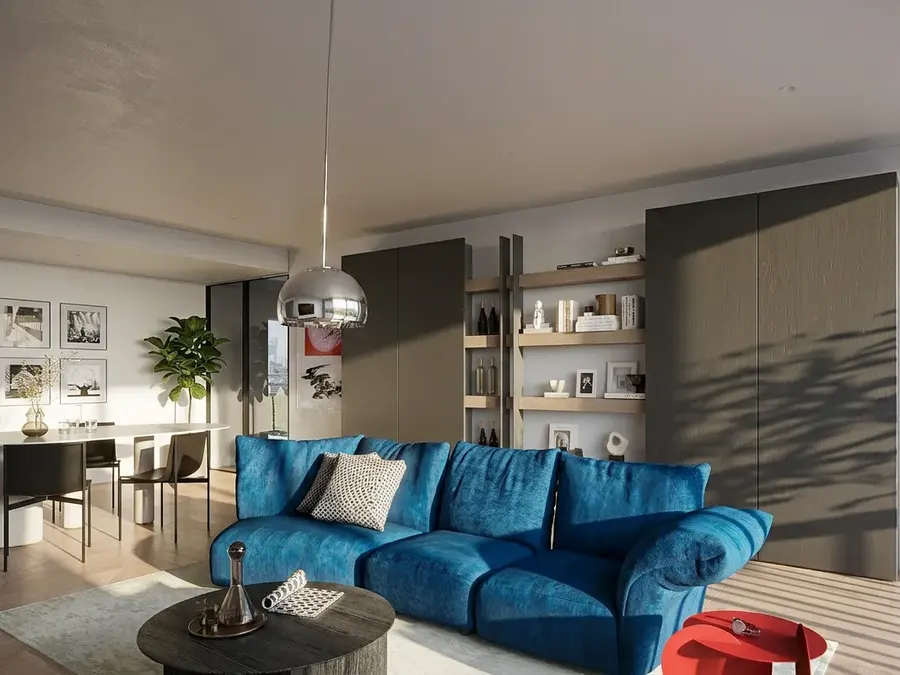 Living e zona pranzo: living con divano blu e libreria